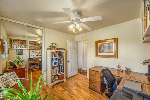 a view of a workspace with furniture and wooden floor