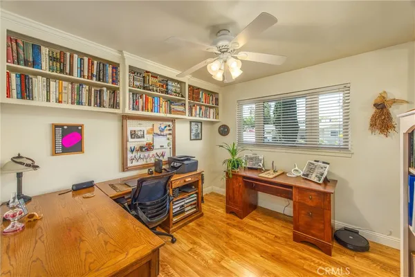 a living room with furniture cabinets and a window