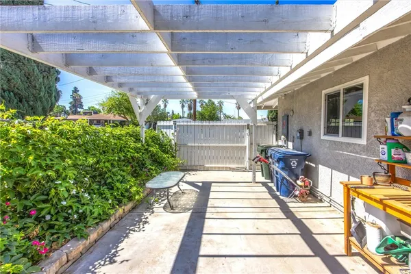 a view of a patio with table and chairs and potted plants