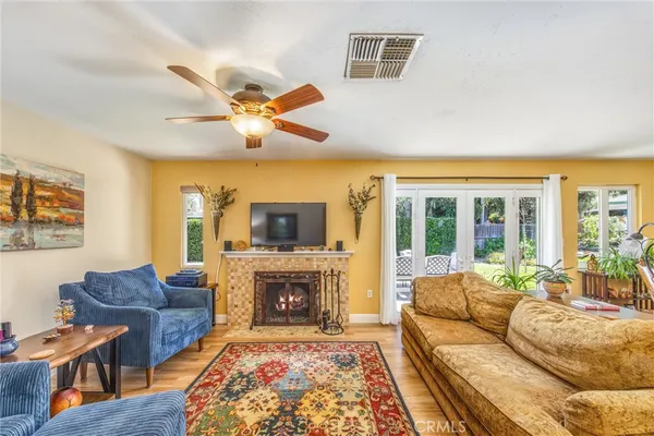 a living room with furniture a fireplace and a flat screen tv