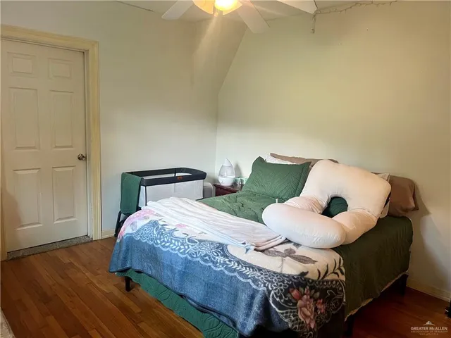 a bedroom with a bed and a mirror