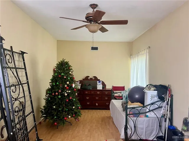 a front view of a house with a garden and trees