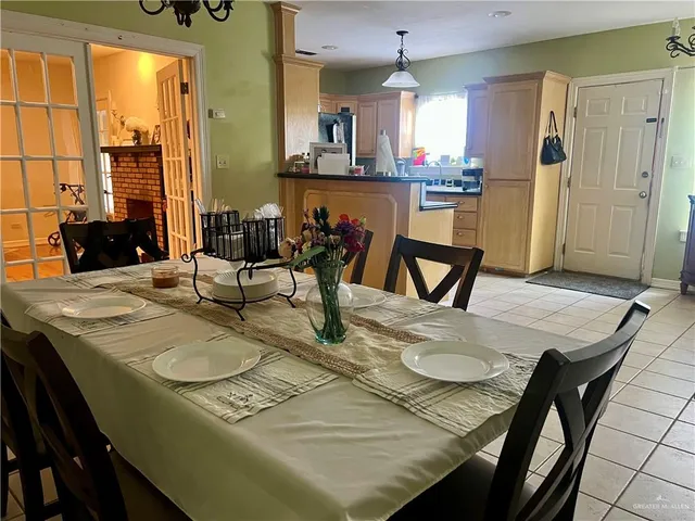a view of a dining room with furniture and chandelier