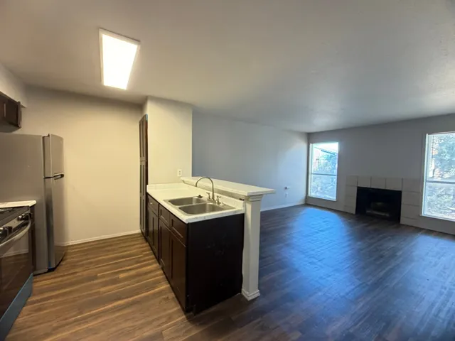 a kitchen with a sink and refrigerator
