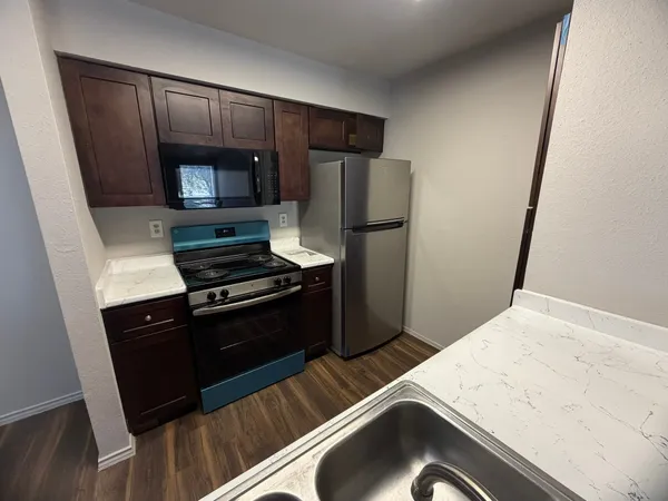 a kitchen with a refrigerator stove and microwave