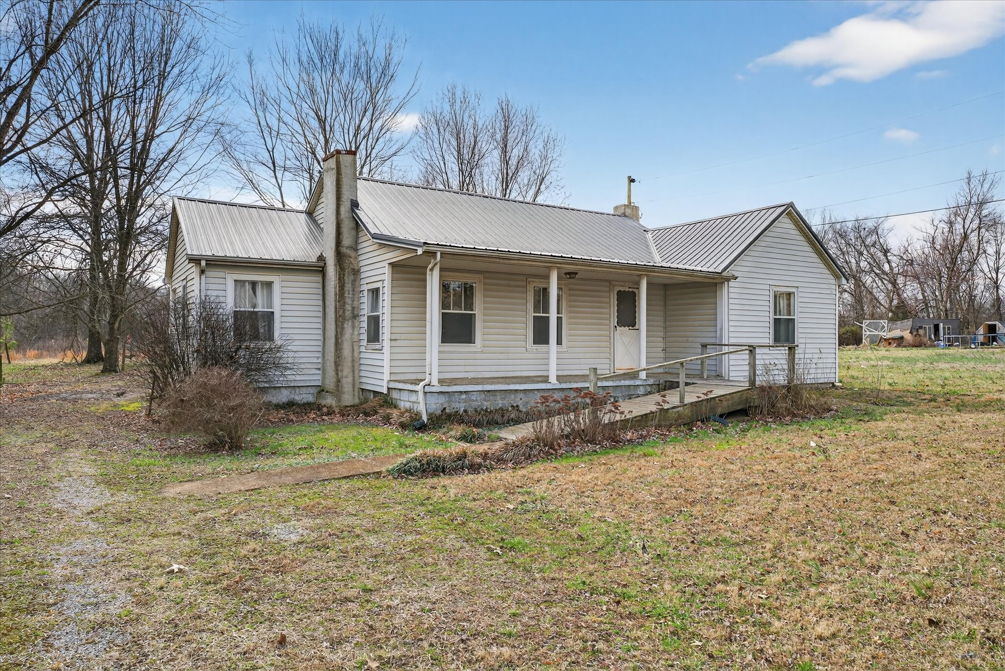 3236 Dover Road Woodlawn, TN 37191 - Photo 3 of 38 a backyard of a house with garden and barbeque oven