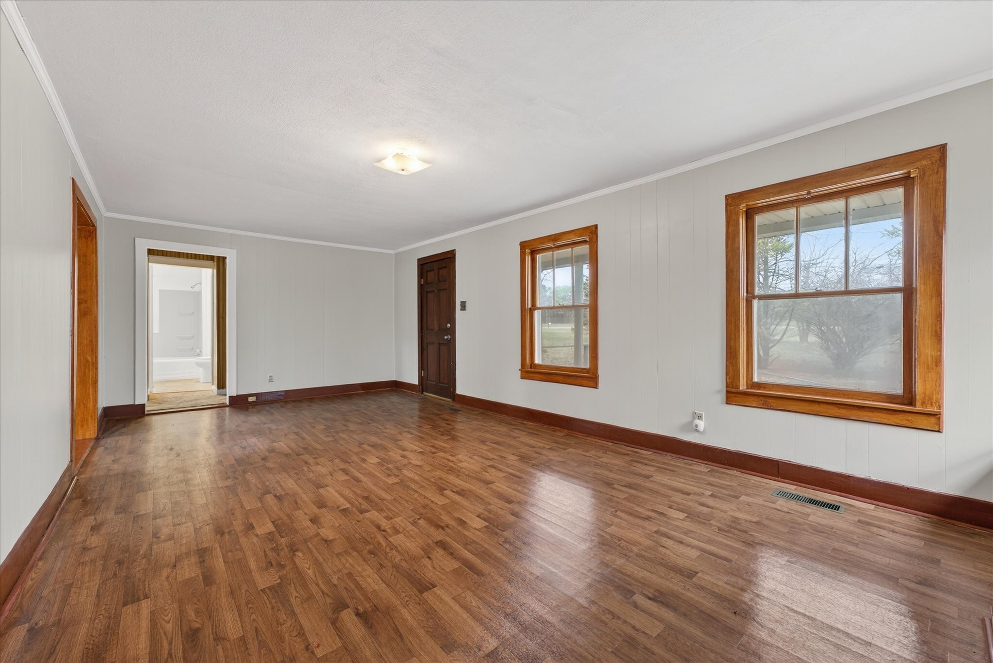 3236 Dover Road Woodlawn, TN 37191 - Photo 8 of 38 a view of an empty room with wooden floor and a window