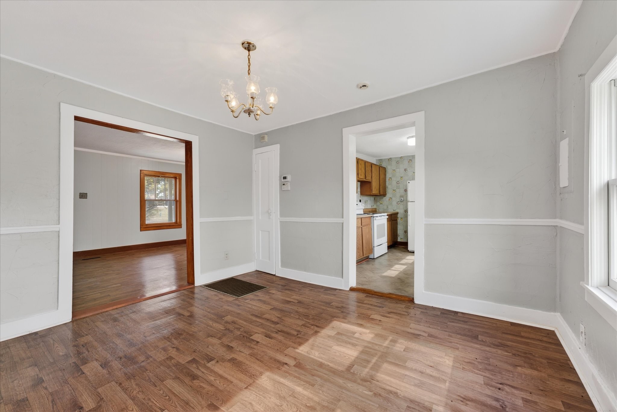 3236 Dover Road Woodlawn, TN 37191 - Photo 9 of 38 an empty room with wooden floor chandelier and windows