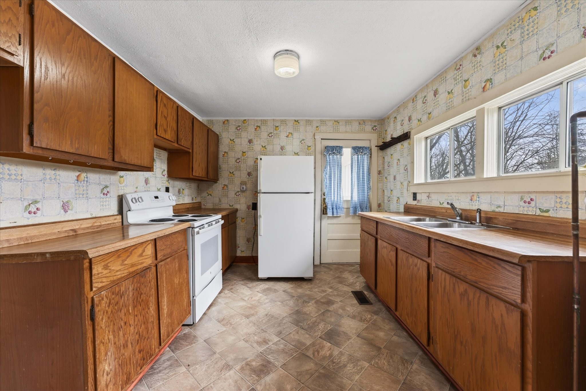 3236 Dover Road Woodlawn, TN 37191 - Photo 10 of 38 a kitchen with a refrigerator sink stove and cabinets