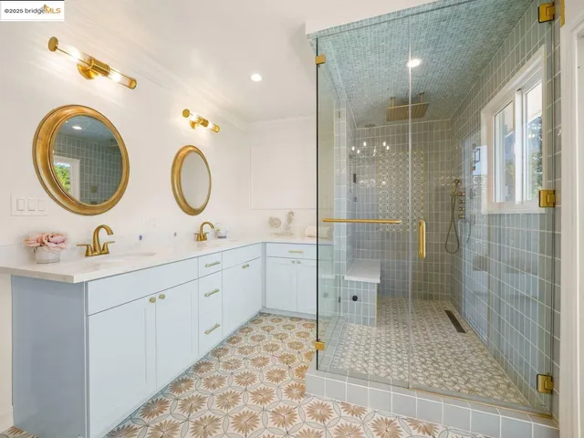 a bathroom with a double vanity sink mirror and shower