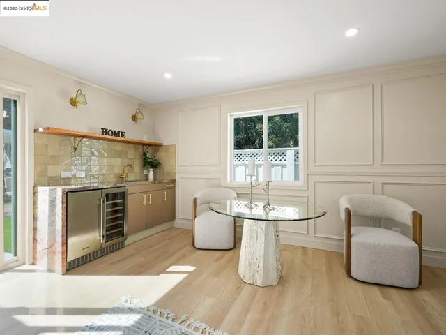 a dining room with furniture and wooden floor