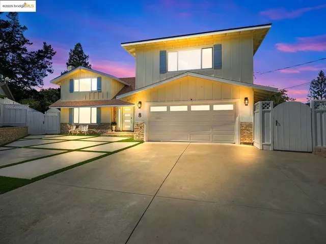 an aerial view of multiple houses with a yard