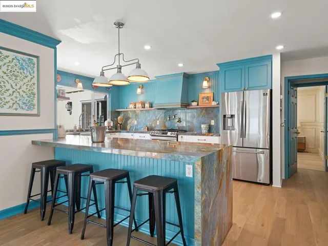 a kitchen with refrigerator and cabinets