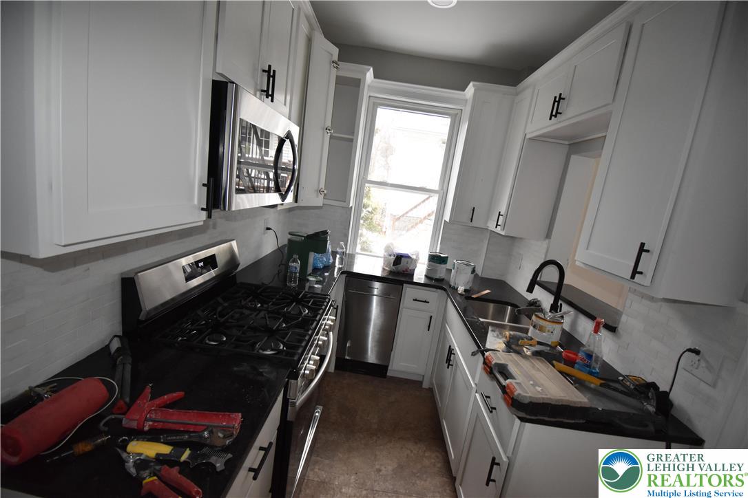 312 March Street, Unit 2 Easton, PA 18042 - Photo 7 of 10 a kitchen with a sink stove and cabinets