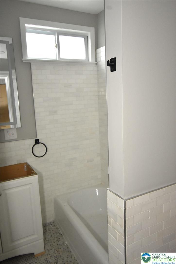 312 March Street, Unit 2 Easton, PA 18042 - Photo 10 of 10 a bathroom with a sink a toilet a window and shower