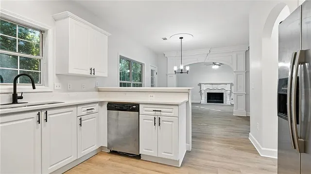 a kitchen with cabinets and wooden floor