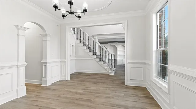 a view of entryway and hall with wooden floor