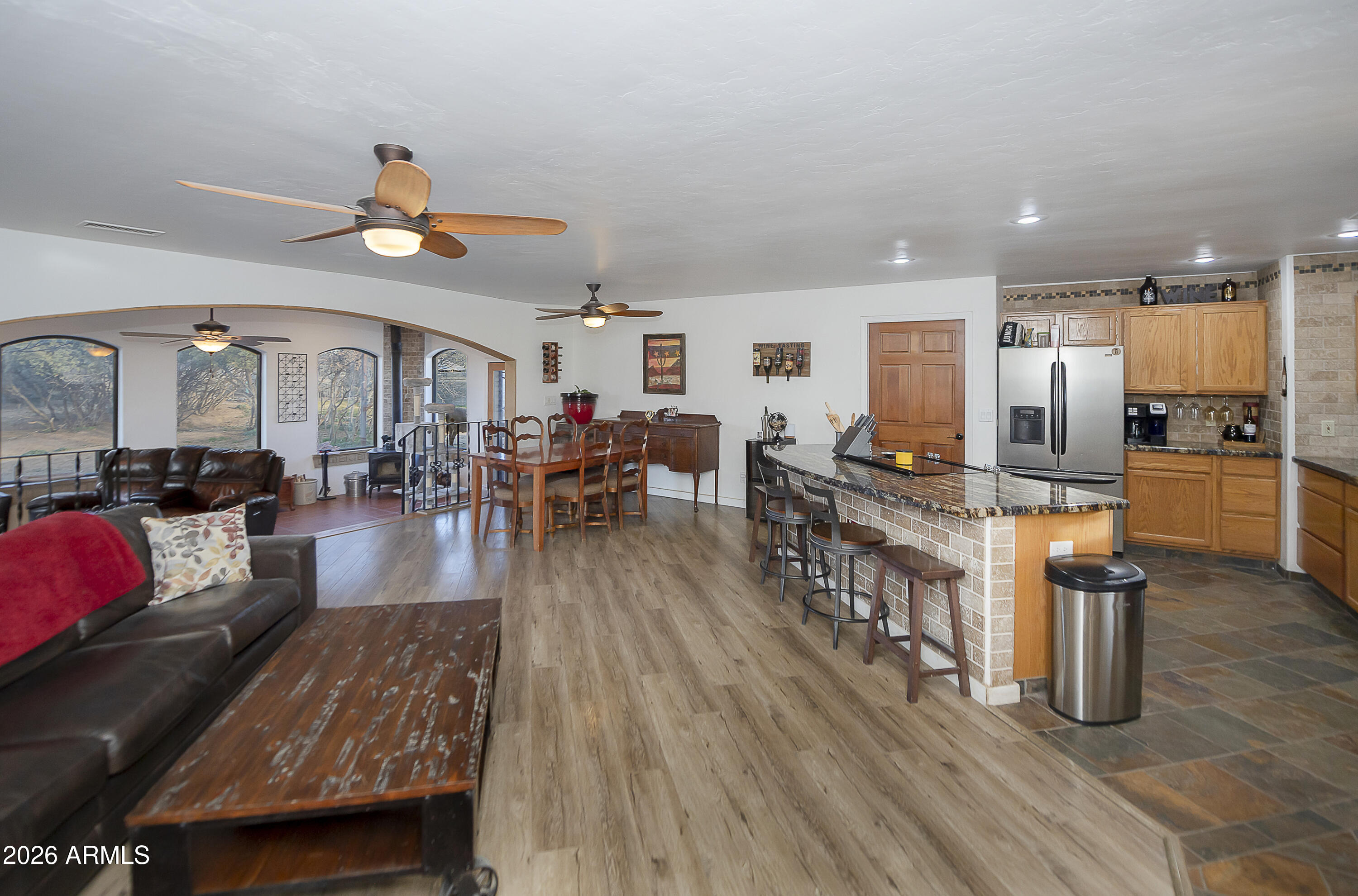 6565 Musgrove Road Skull Valley, AZ 86338 - Photo 13 of 67 a living room with furniture kitchen view and a wooden floor