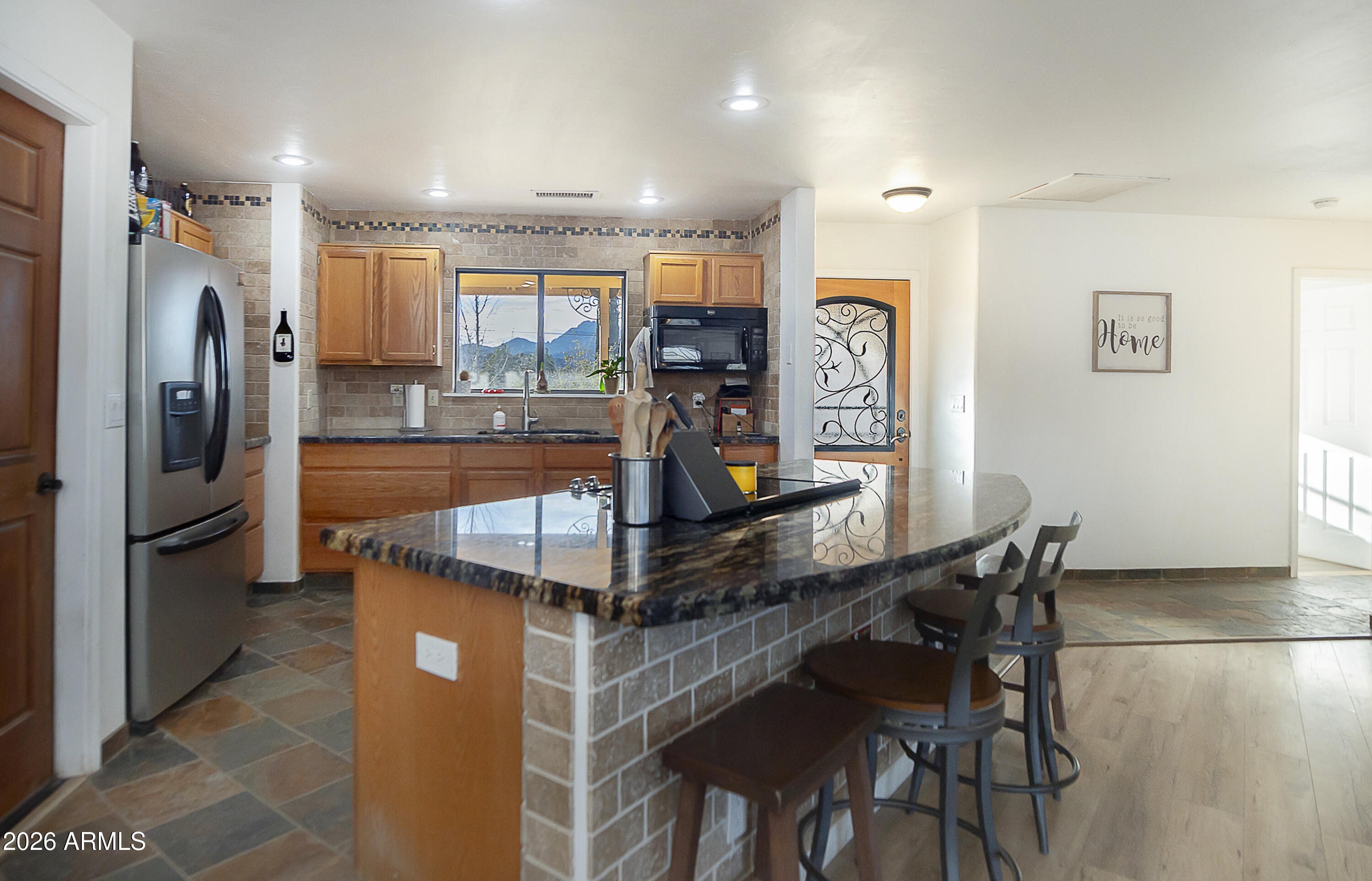 6565 Musgrove Road Skull Valley, AZ 86338 - Photo 14 of 67 a view of a dining room with furniture window and wooden floor