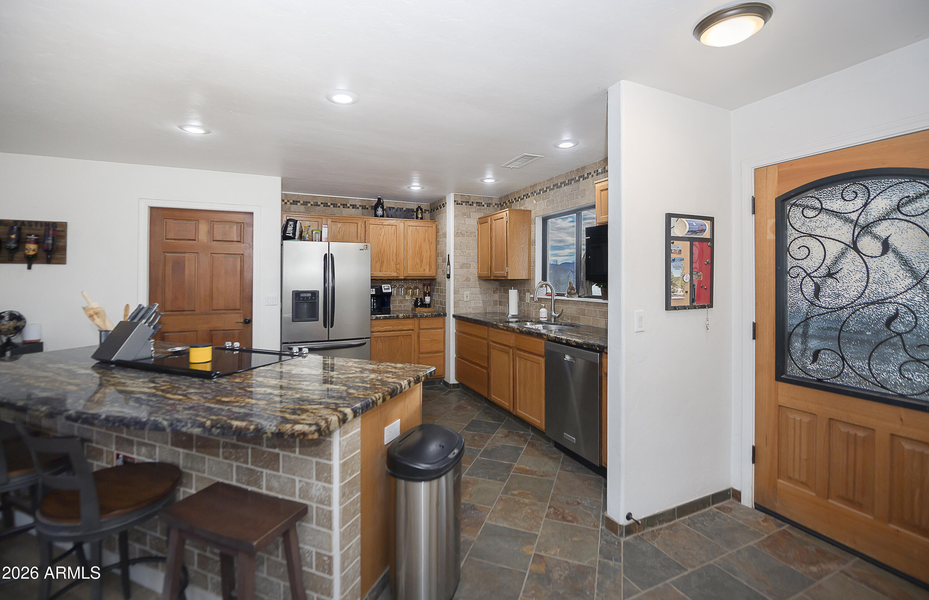 6565 Musgrove Road Skull Valley, AZ 86338 - Photo 15 of 67 a kitchen with refrigerator a stove and chairs