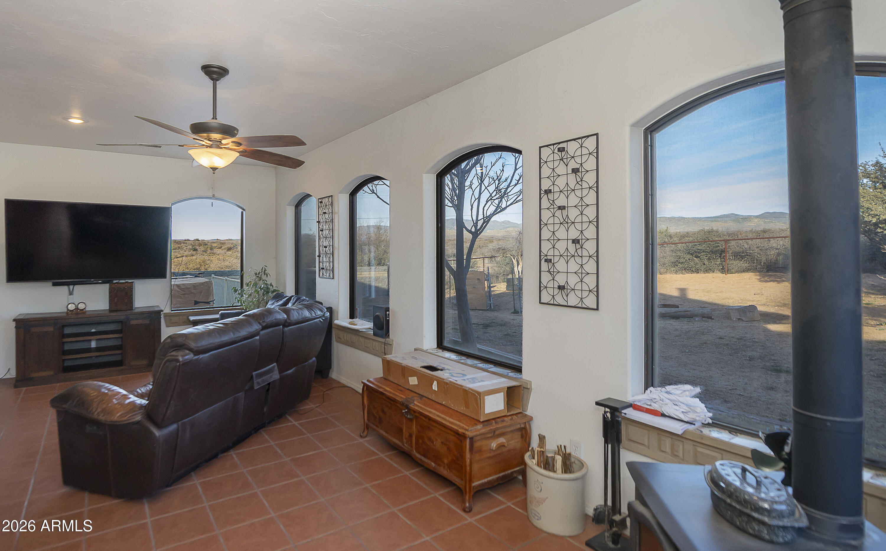 6565 Musgrove Road Skull Valley, AZ 86338 - Photo 19 of 67 a living room with furniture and a flat screen tv