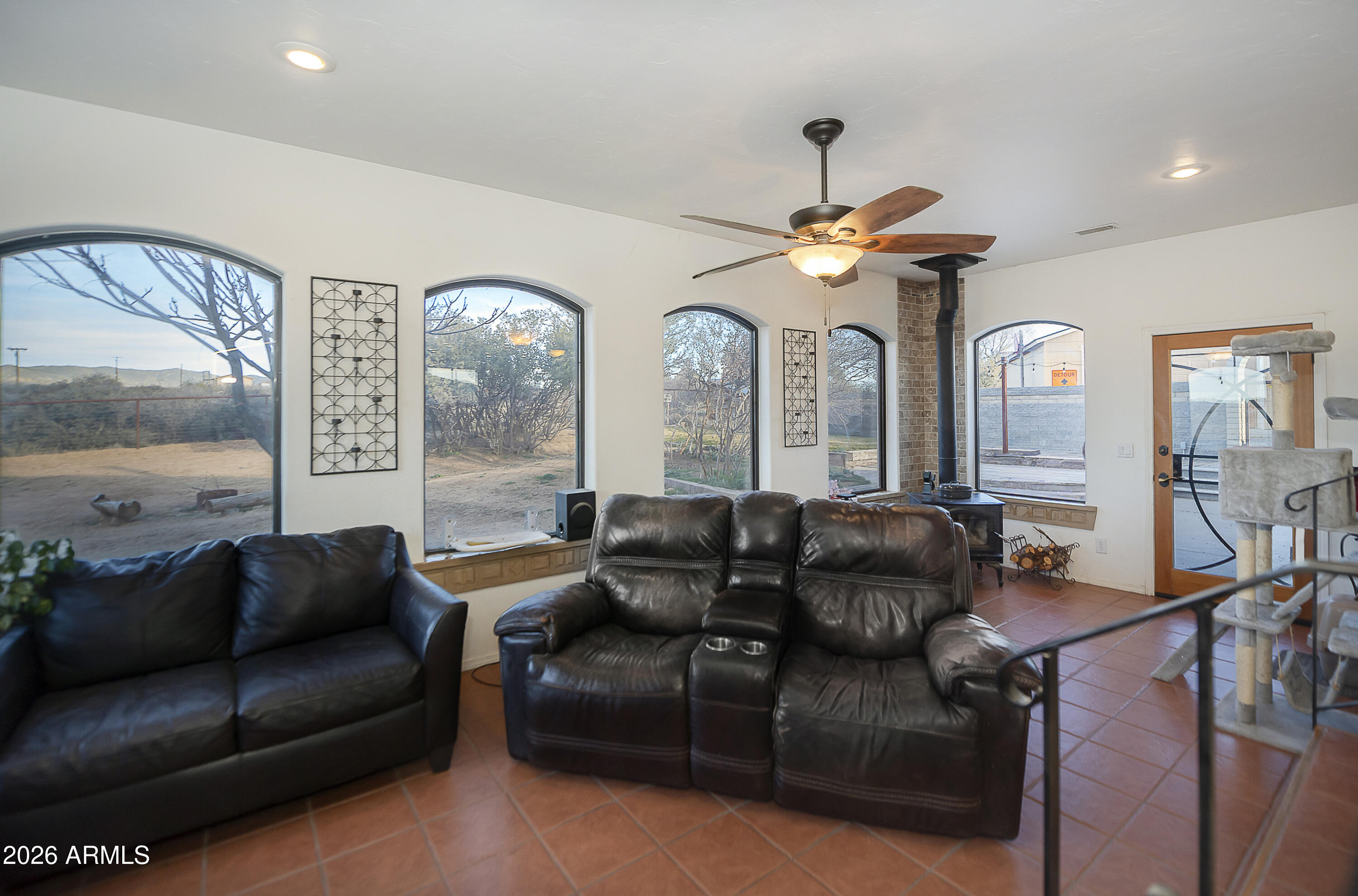 6565 Musgrove Road Skull Valley, AZ 86338 - Photo 20 of 67 a living room with furniture a large window and a chandelier