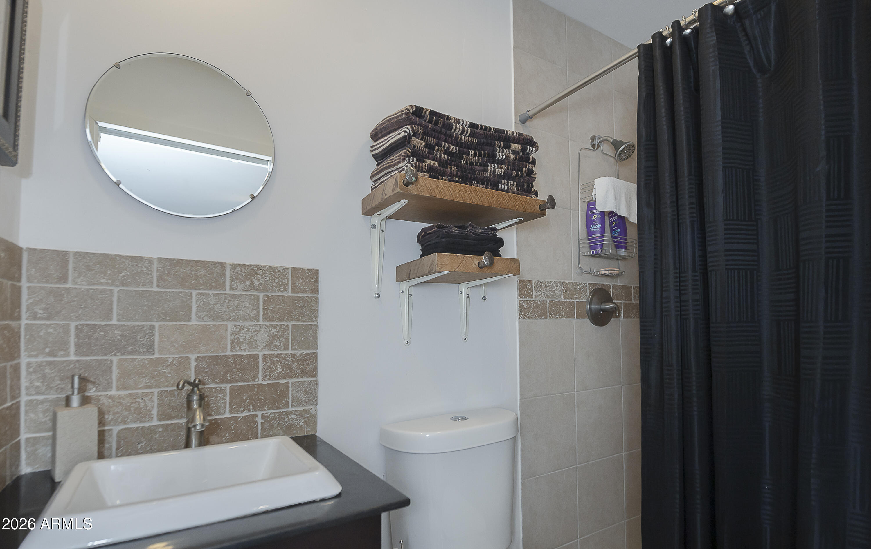 6565 Musgrove Road Skull Valley, AZ 86338 - Photo 54 of 67 a bathroom with a toilet a sink and mirror