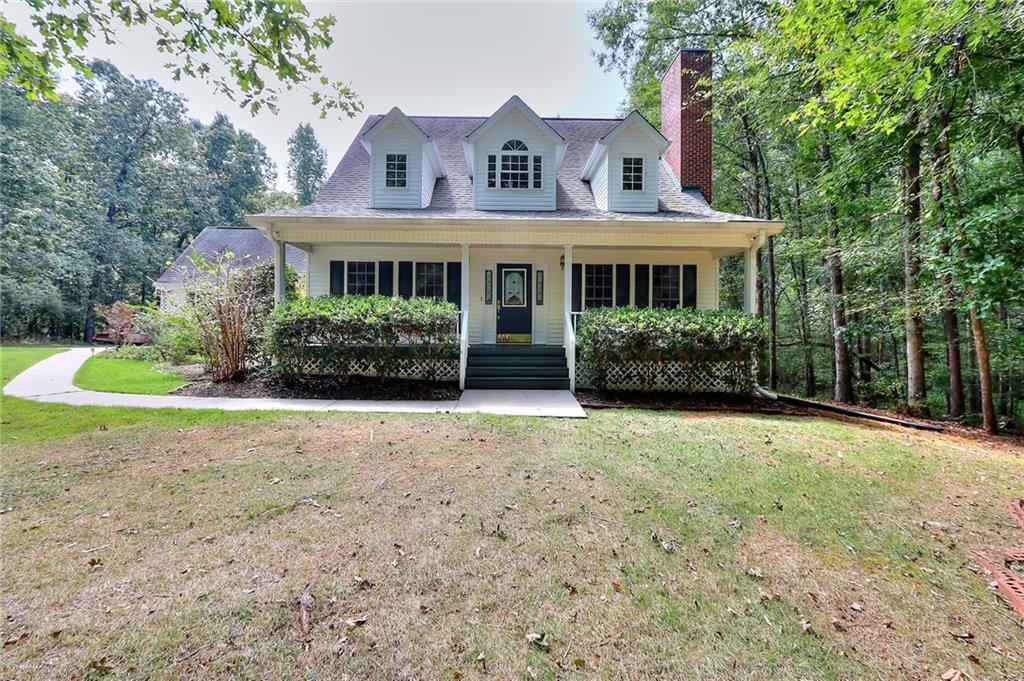 152 Smokey Hollow Road Jefferson, GA 30549 - Photo 1 of 1 a front view of a house with garden