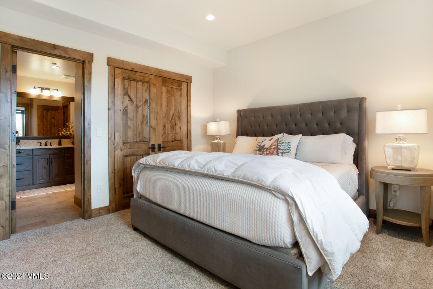 1288 East Haystacker Drive Eagle, CO 81631 - Photo 24 of 34 a spacious bedroom with a bed and a lamp