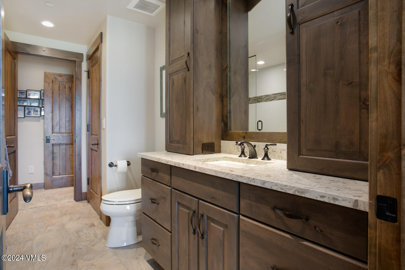 1288 East Haystacker Drive Eagle, CO 81631 - Photo 28 of 34 a bathroom with a granite countertop sink mirror vanity and toilet