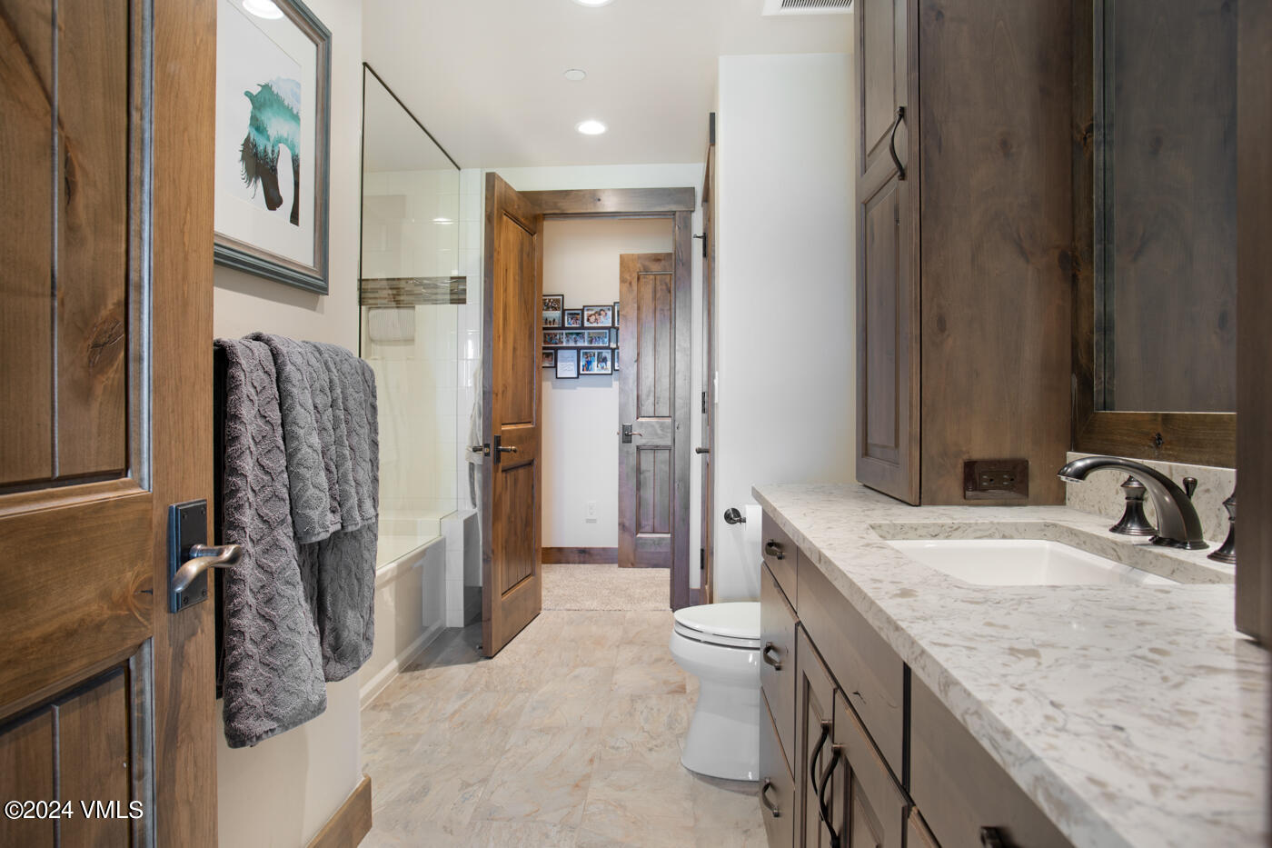 1288 East Haystacker Drive Eagle, CO 81631 - Photo 29 of 34 a bathroom with a granite countertop sink a toilet and shower