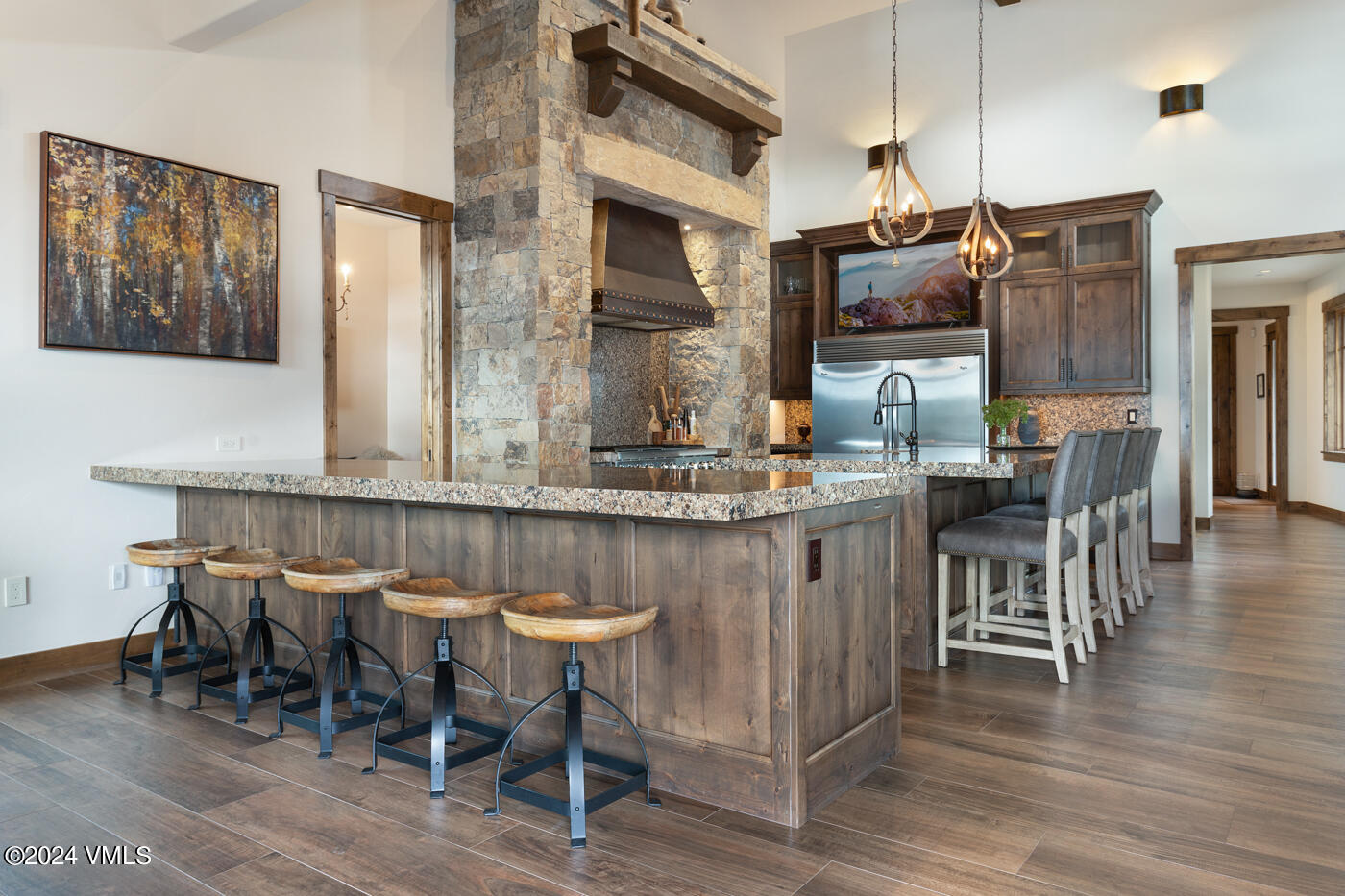 1288 East Haystacker Drive Eagle, CO 81631 - Photo 7 of 34 a kitchen with stainless steel appliances granite countertop a table chairs and a refrigerator