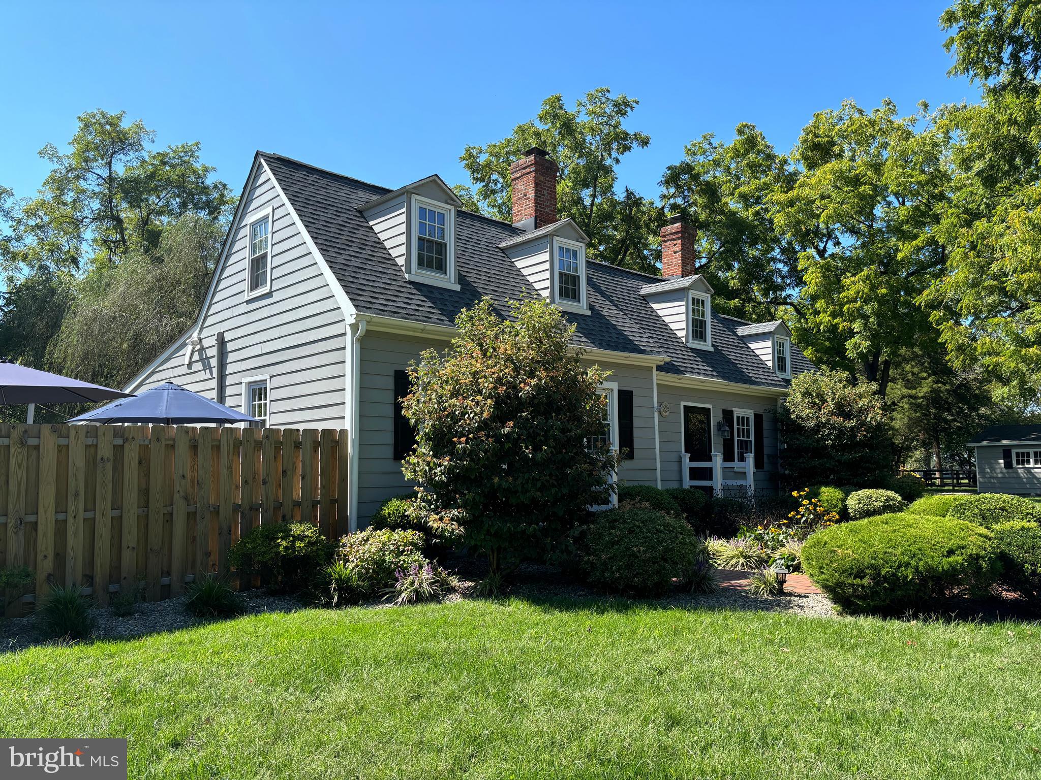 a front view of a house with a garden and plants