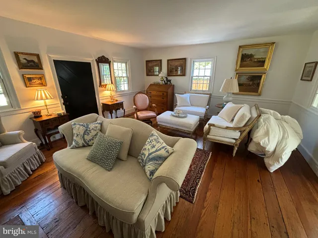 a bedroom with furniture and wooden floor