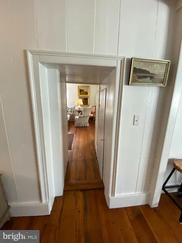 a view of walk in closet with wooden floor