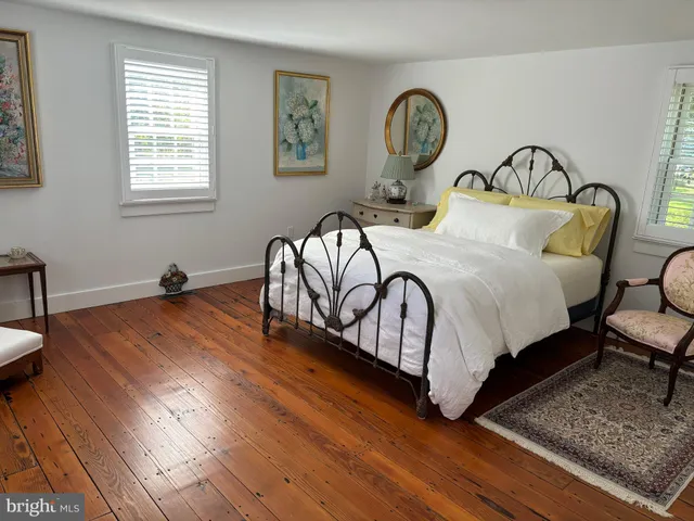 a bedroom with bed and a window