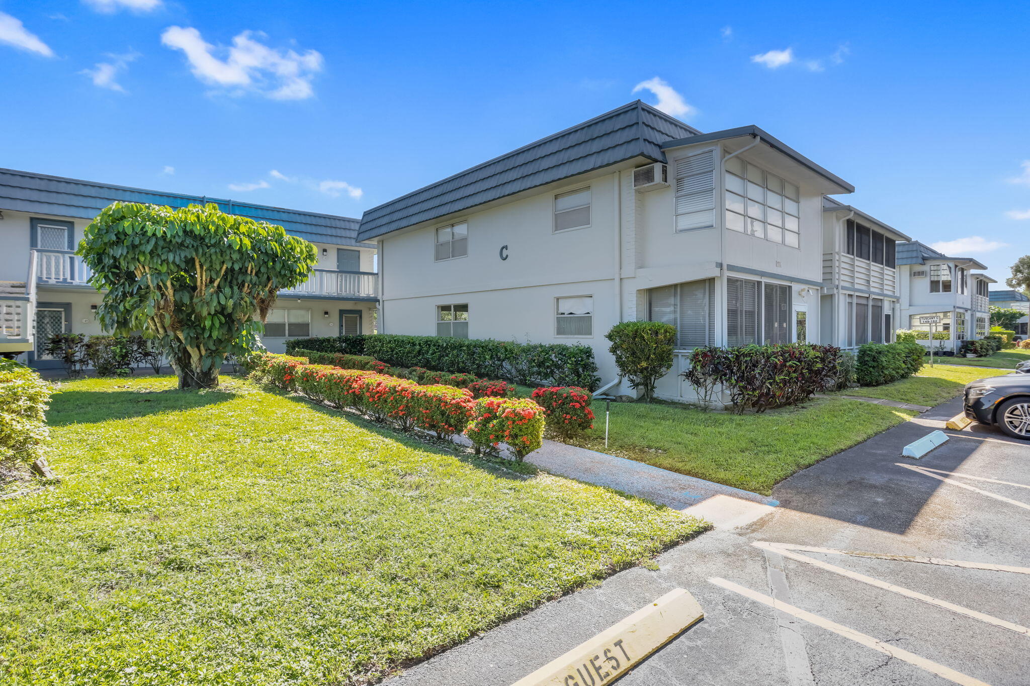 152 Tuscany Lane, Unit C Delray Beach, FL 33446 - Photo 1 of 40 a swimming pool with outdoor seating and yard