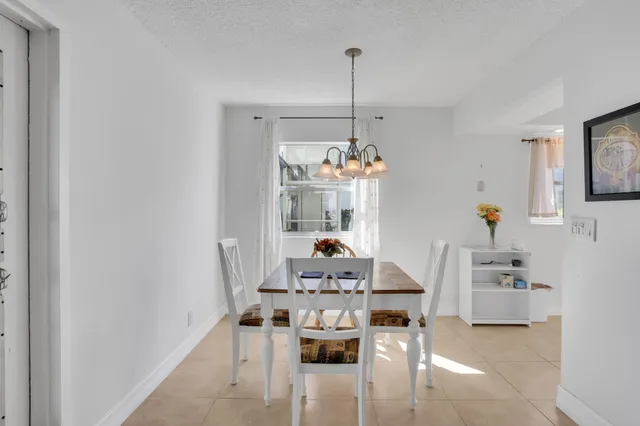 a kitchen with a refrigerator sink and white cabinets