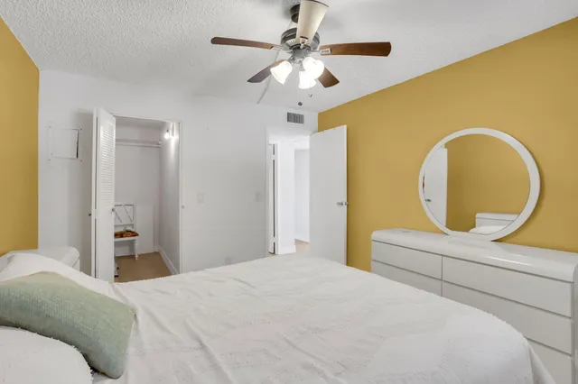 a bathroom with a sink vanity mirror and toilet