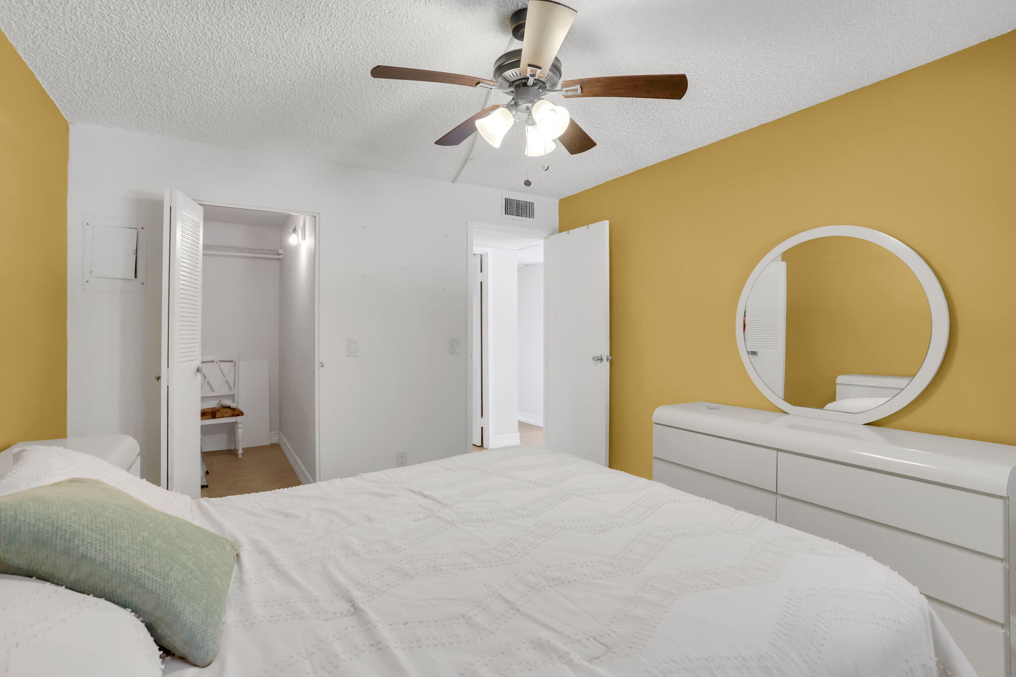 152 Tuscany Lane, Unit C Delray Beach, FL 33446 - Photo 15 of 40 a bedroom with a bed and a chandelier