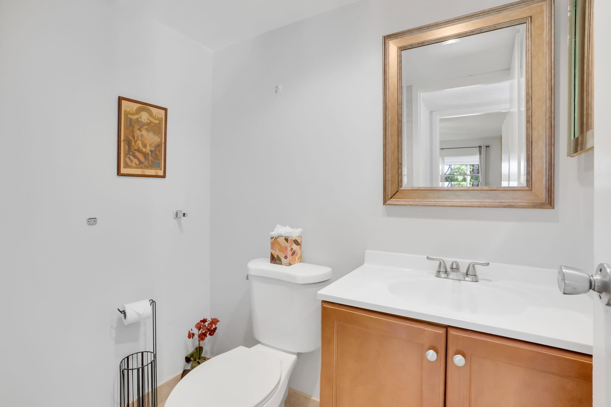 152 Tuscany Lane, Unit C Delray Beach, FL 33446 - Photo 16 of 40 a bathroom with a sink vanity mirror and toilet