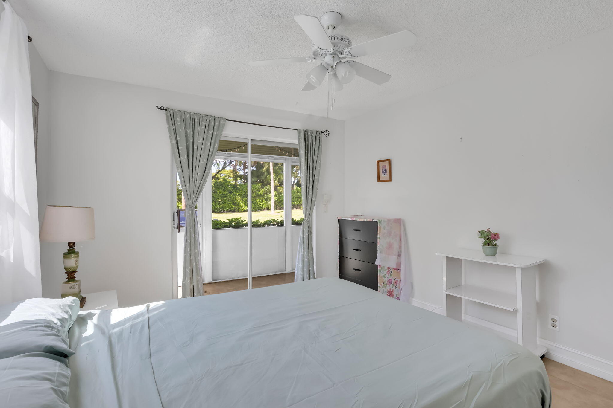 152 Tuscany Lane, Unit C Delray Beach, FL 33446 - Photo 17 of 40 a bedroom with a bed and a window