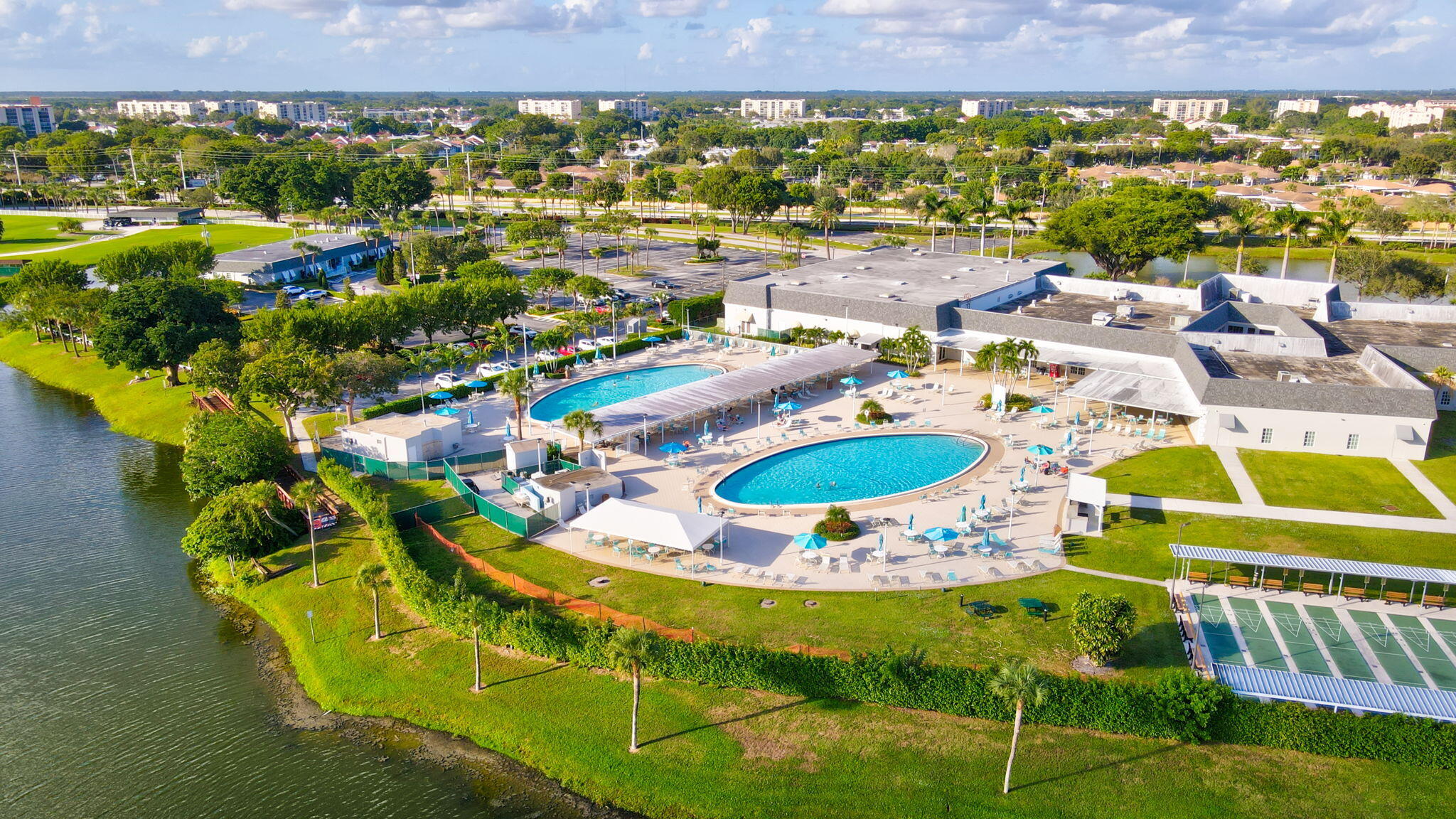 152 Tuscany Lane, Unit C Delray Beach, FL 33446 - Photo 24 of 40 a view of swimming pool and outdoor seating