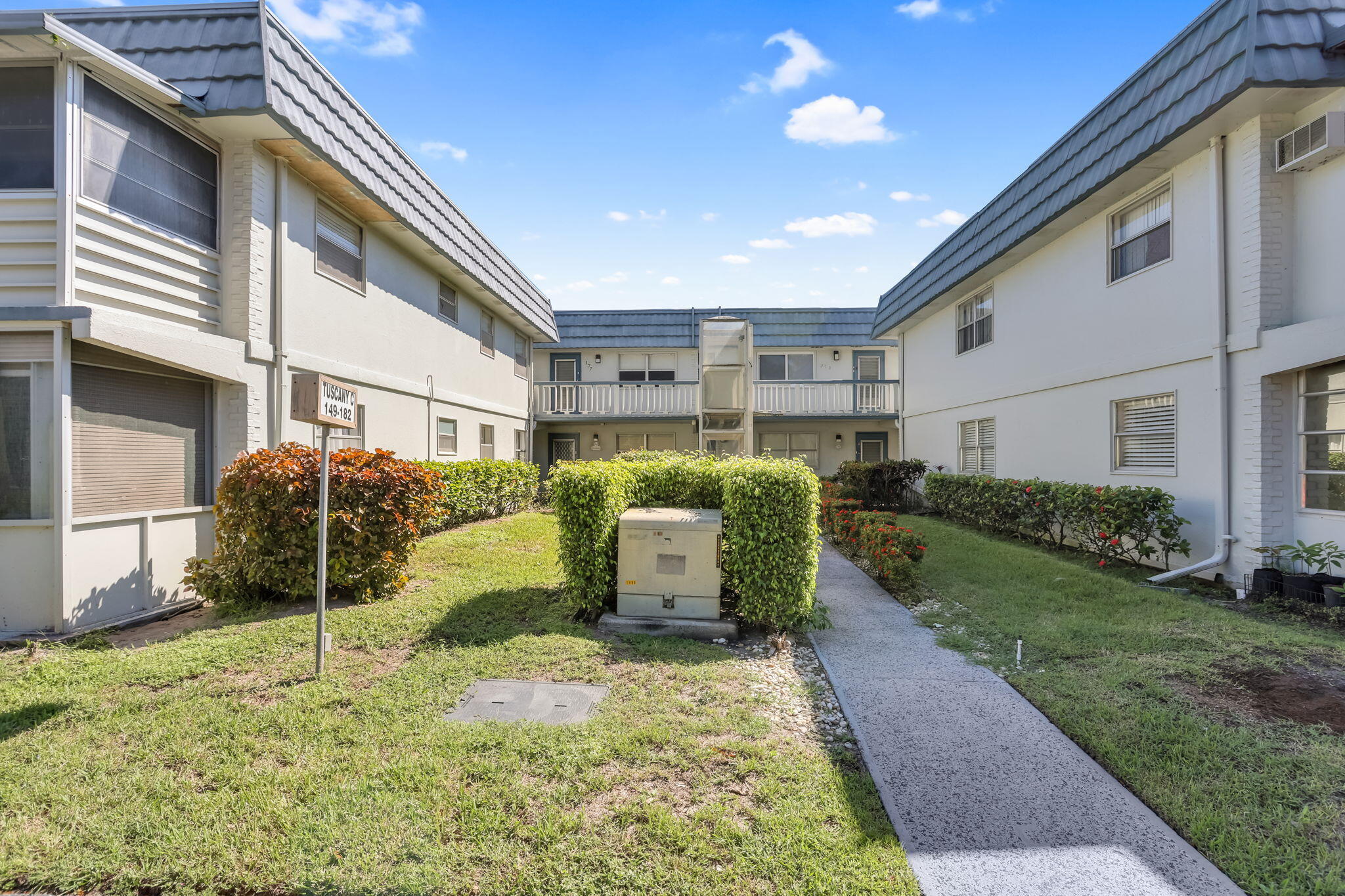 152 Tuscany Lane, Unit C Delray Beach, FL 33446 - Photo 25 of 40 a backyard of a house with barbeque oven and outdoor seating