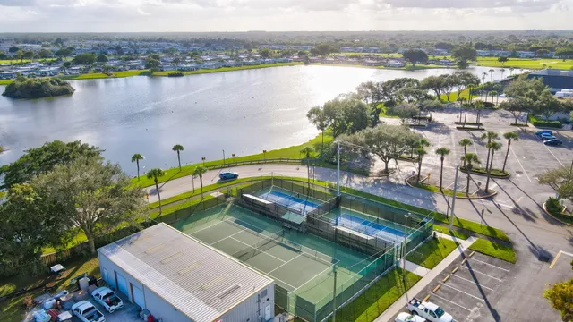 an aerial view of residential houses with outdoor space and swimming pool