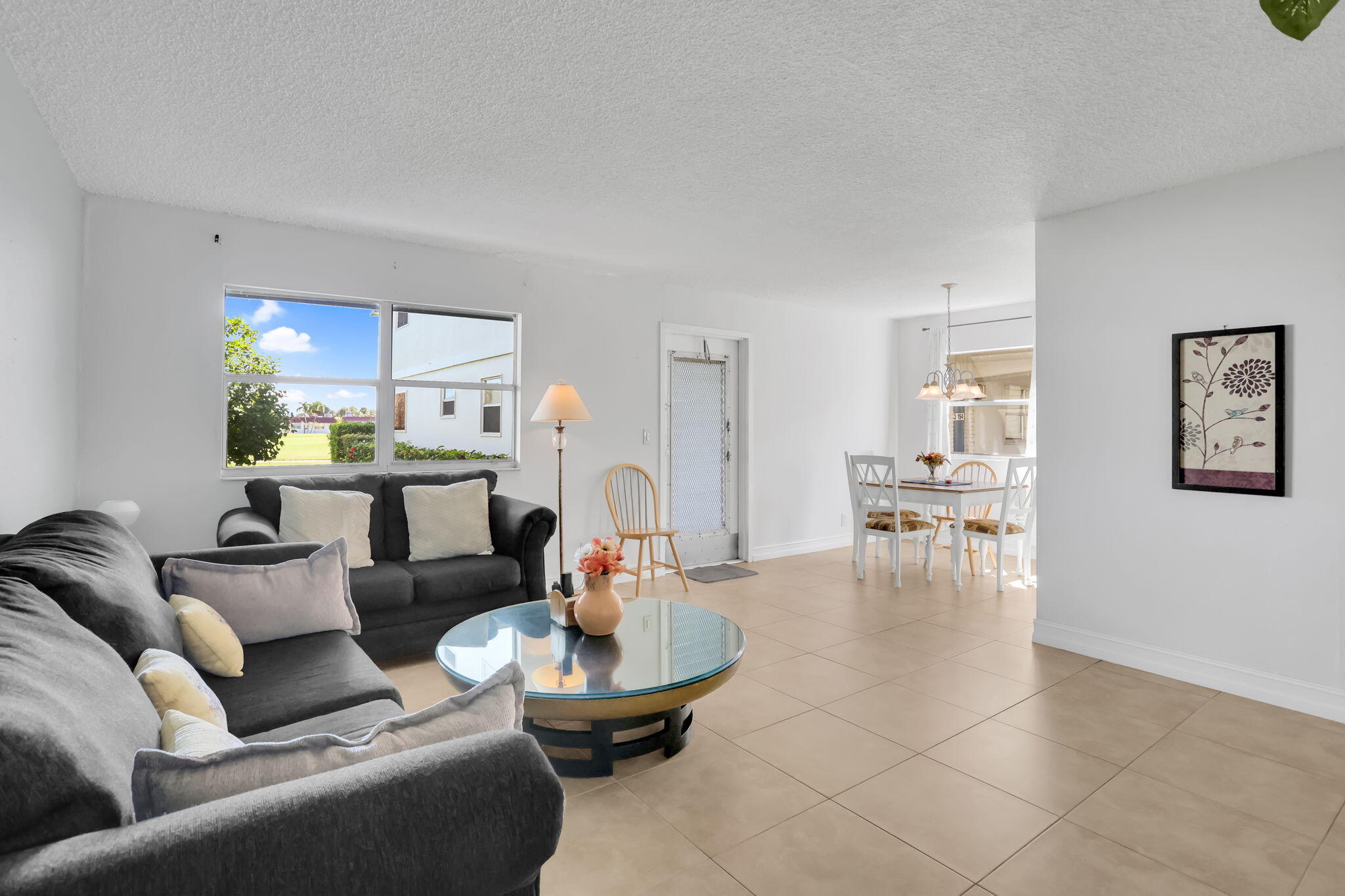 152 Tuscany Lane, Unit C Delray Beach, FL 33446 - Photo 6 of 40 a living room with furniture and view of kitchen