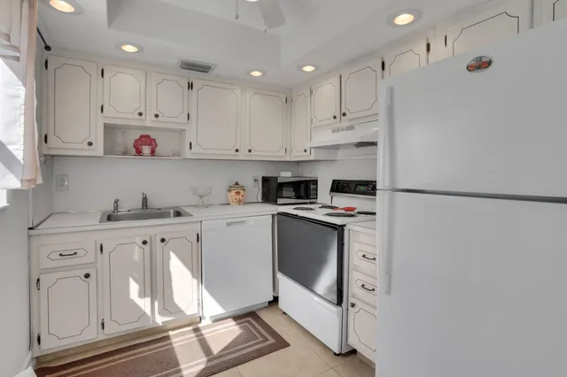 a kitchen with stainless steel appliances a refrigerator and a table
