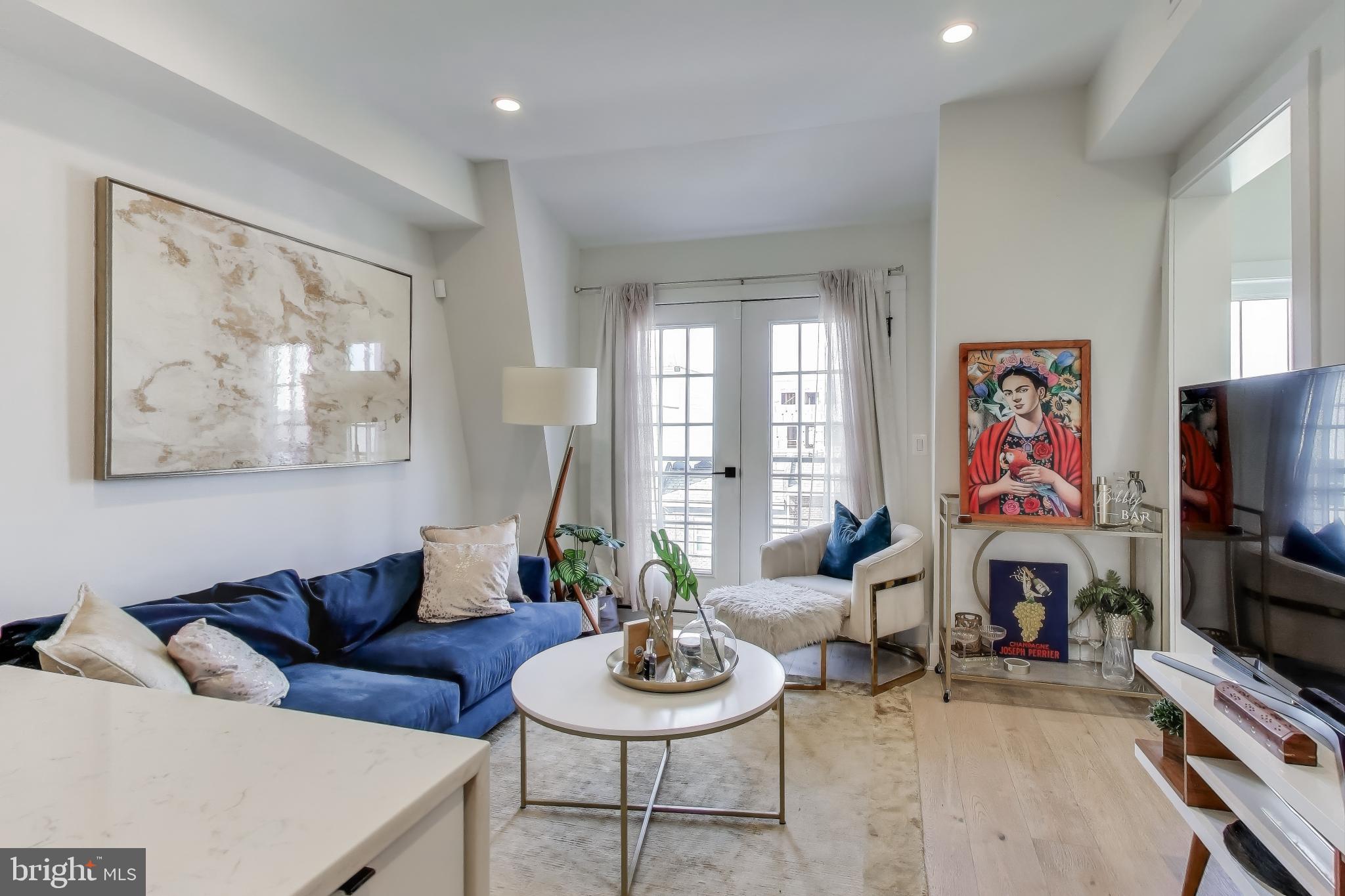 1011 18th Street Northeast, Unit 8 Washington, DC 20002 - Photo 5 of 25 a living room with furniture and a flat screen tv