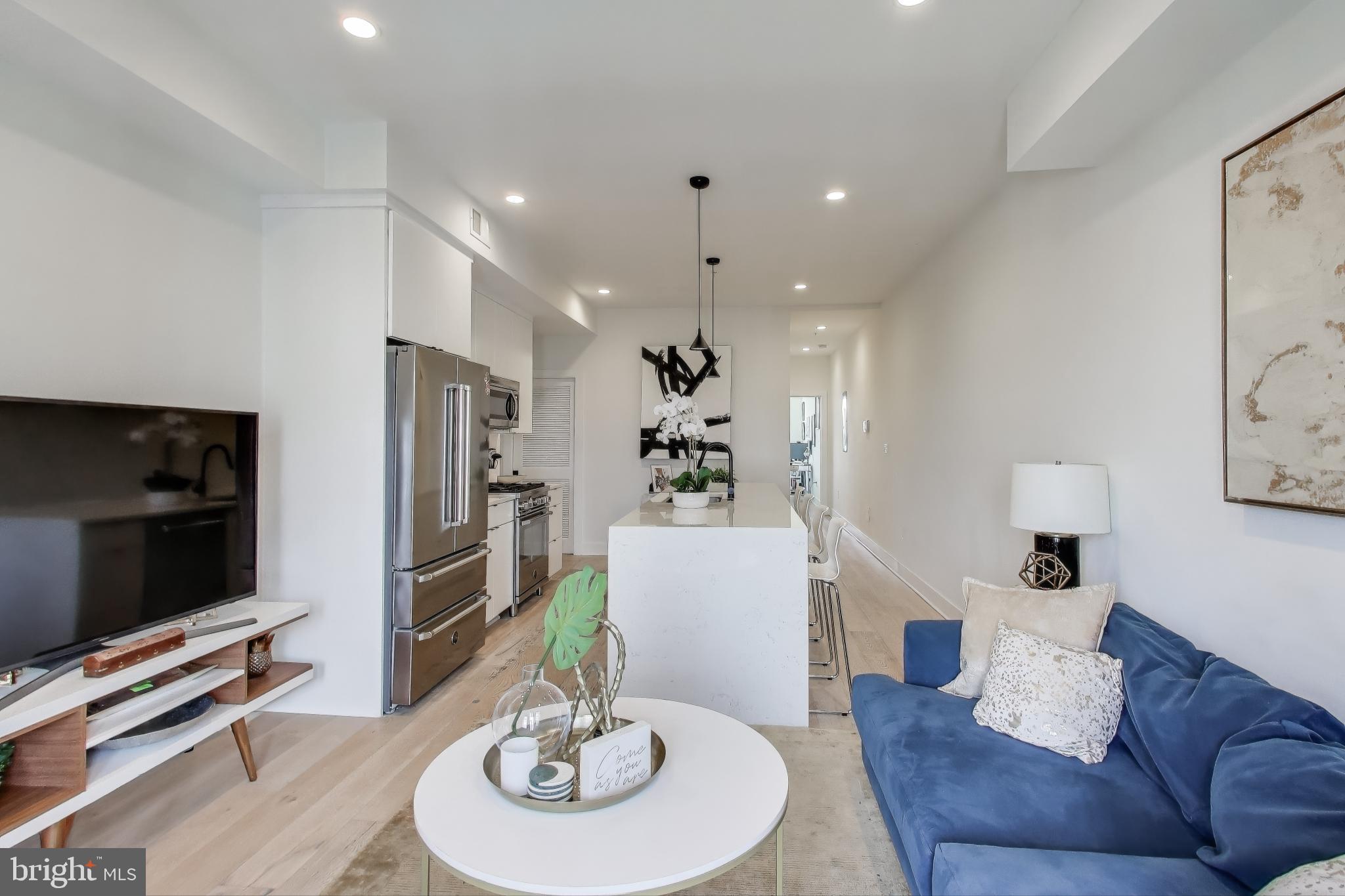 1011 18th Street Northeast, Unit 8 Washington, DC 20002 - Photo 7 of 25 a living room with furniture and a flat screen tv