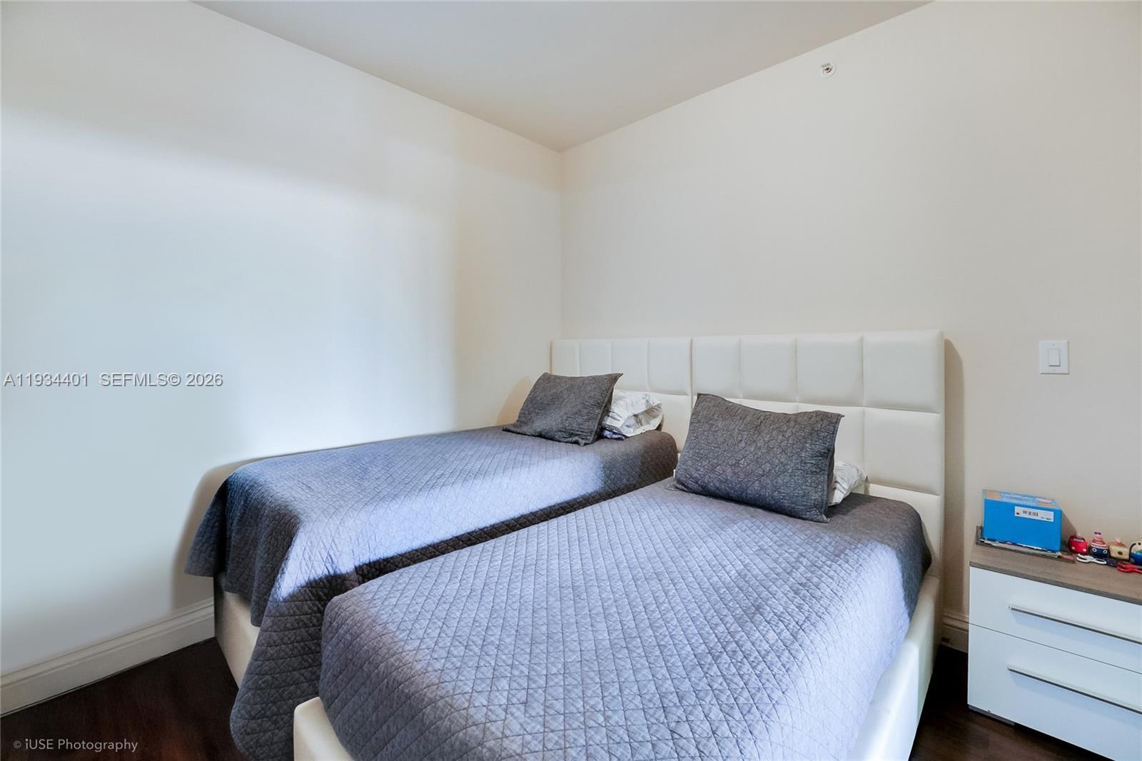 9559 Collins Avenue, Unit S5F Surfside, FL 33154 - Photo 11 of 27 a bedroom with a bed and wooden floor